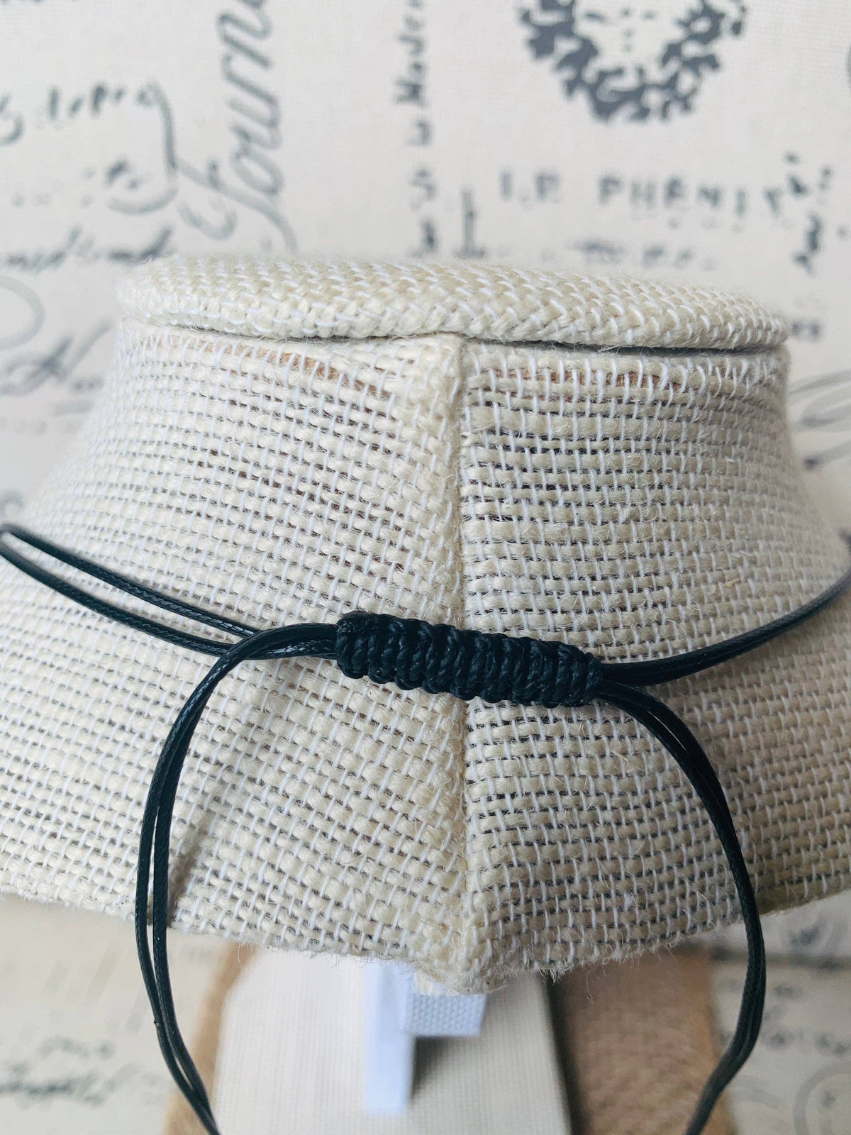 MÍSTIKA Tagua Sunlit Petals Necklace – Close-up of adjustable black cord knot detail on linen display | Místika Style