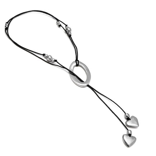 Vestopazzo Oval and Heart Pendant Necklace – Adjustable black cord with silver oval ring and two dangling heart charms on white background | Místika Style