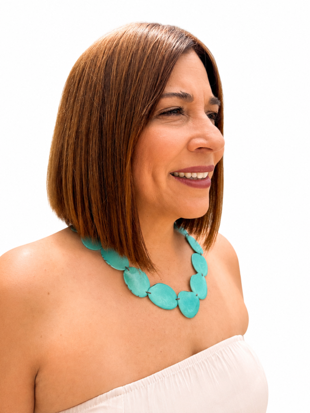 MÍSTIKA Tagua Sunlit Petals Necklace in Turquoise – Side profile of smiling woman wearing turquoise tagua necklace with white strapless top | Místika Style
