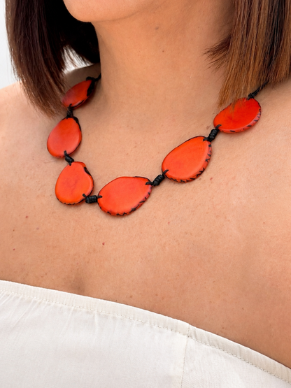 MÍSTIKA Tagua Sunlit Petals Necklace in Orange – Lifestyle photo worn on model with white top | Místika Style